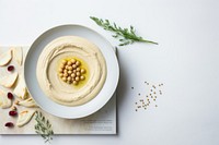 A White beige minimalistic photography of hummus in cook book style plate food meal.