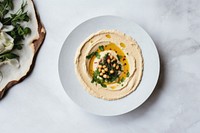 A White beige minimalistic photography of hummus in cook book style bread plate food.