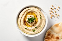 A White beige minimalistic photography of Homemade hummus in cook book style bread plate food.
