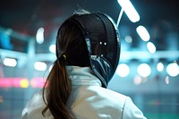 Woman fencing adult person headphones.