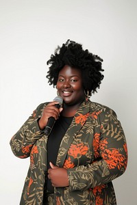 A black chubby woman lecturer holding a microphone portrait smiling adult.