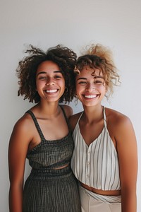 Two friends laughing standing portrait.