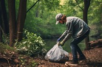 Environmental activist picking up garbage gardening outdoors nature.