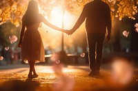 Couple holding hands sunlight outdoors adult.