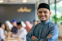Muslim man stand and smile against business people meeting in meeting room adult happiness portrait.