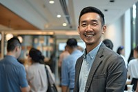 Asian man stand and smile against business people meeting in meeting room adult architecture accessories.