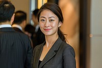 Asian woman stand and smile against business people meeting adult hairstyle happiness.
