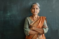 Indian woman teacher cross arm against black board blackboard adult contemplation.