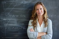 White woman teacher cross arm against black board blackboard adult intelligence.