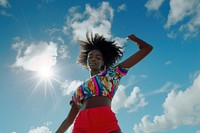 Black young woman dancing sky outdoors.