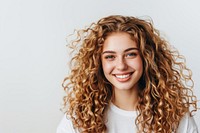 Woman with curly hair smiling adult smile hairstyle.