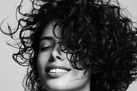 Woman with curly hair smiling portrait adult white.