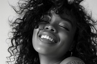 Woman with curly hair smiling laughing portrait teeth.