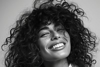 Woman with curly hair smiling portrait laughing smile.