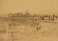Group portrait with train on bridge by Altobelli and Molins