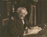 Félix Nadar seated at writing table by Paul Nadar