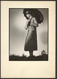 Woman in coat with umbrella by Günther Krampf