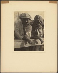 Two Black Boys in Caps Leaning Over Wooden Railing by Doris Ulmann