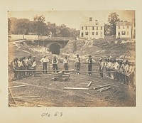 Railroad construction workers straightening rails by A J Russell