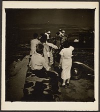 Group Seated on Stone Wall over Coast by Louis Fleckenstein