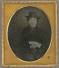 Portrait of a Seated Man in Hat with Hands Crossed