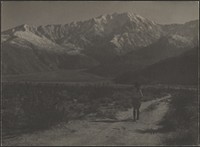 Woman Walking on Path Towards Mountains by Louis Fleckenstein