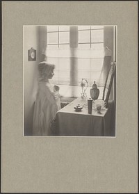 Young Girl in Costume Looking Into a Mirror Resting on a Table by Guido Rey