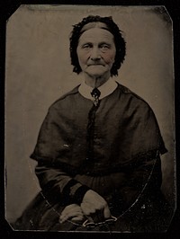 Portrait of a Seated Elderly Woman Holding Her Glasses