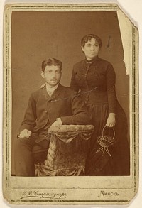 Portrait of a young couple: man seated and woman standing by M W Straschuner
