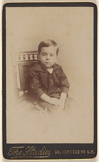 Unidentified little boy seated, printed in vignette-style by The Studio