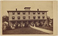 View of a house with numerous people on porch and lawn by Yeaw and Company