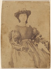 Unidentified woman wearing a hat and open-fingered gloves, seated