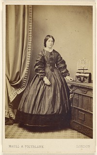 Unidentified woman wearing a long dress, standing by Maull and Polyblank