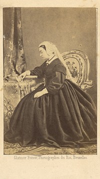 Portrait of Queen Victoria seated, gazing at a photograph of Prince Albert by Ghémar Frères