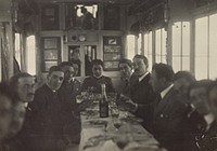 Men seated around a table by Fédèle Azari