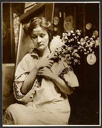 Female Model Holding Flowers by Alphonse Maria Mucha