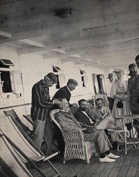 Members of the British Association playing at phrenology on board a ship on its way to South Africa. Photograph by J.T. Bottomley, 1905.
