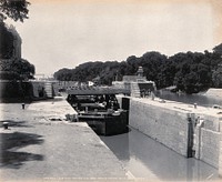 Menufia Canal, Egypt: reconstruction work to the first Aswan Dam: a barge carries away defunct wooden lock gates. Photograph by F. Fiorillo, 1910.