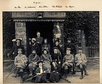 Pen-y-Gwryd, Wales: a mountaineering party seated outside Penygwryd Hotel, eight men, six women. Photograph by G.D. and A. Abraham, 1897.
