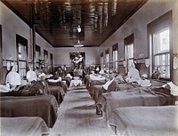 Johannesburg Hospital, South Africa: hospital ward with male patients, many with bandaged heads. Photograph, c. 1905.