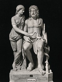 Aesculapius and Hygieia: the Greek god of healing with his daughter the Greek goddess of health. Photograph by Alinari, 1900/1920 , of a sculpture.
