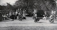 The Maidan park, Calcutta, India: traditional Sikkim Devil dancers performing for King George V and Queen Mary (then the Prince and Princess of Wales) on their visit in 1906. Photograph, 1906.