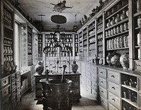 A seventeenth-century German apothecary's shop with ornate pharmacy jars, large metal mortars and a stuffed turtle hanging from the ceiling; recreated for the German National Museum in Nuremberg. Photograph by Christof Müller.