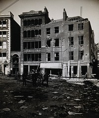 The church of St. Bartholomew the Great and the surrounding area, Bartholomew Close after the Zeppelin air raid on 8 September 1915. Photograph.