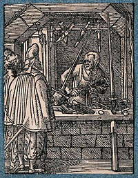 A cutler, or maker of knives, daggers and swords, working in his shop as a customer tests the weight of a sword. Woodcut by J. Amman.