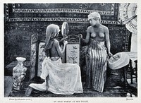 An Arab woman at her toilet; to the right another woman looks on. Half-tone after a photograph.