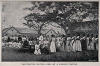 A white doctor vaccinating African girls all wearing European clothes at a mission station. Process print by Meisenbach after a photograph.