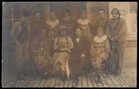 British soldiers in France, one in drag, pose for a group portrait. Photographic postcard, 191-.