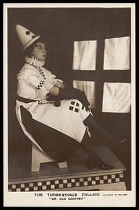 Dan Godfrey dressed in Pierrette costume, performing for "The Timbertown Follies" at a prisoner of war camp in Groningen. Photographic postcard, 191-.