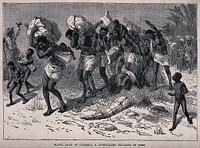 Convoys of female slaves, with children, in Angola, chained together and carrying heavy bundles. Wood engraving.